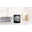 Side view of floral ceramic mug on white background