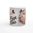 Ceramic mug with faith design, pink roses, butterflies, and gold cross, on a wooden table with plants and sunlight
