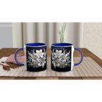 Ceramic mug with floral design and blue handle