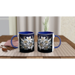 Ceramic mug with floral design and blue handle