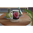 Two floral mugs on wooden table with plants
