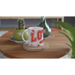 White mug with red lettering on wooden table